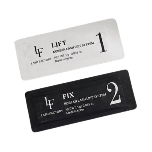 Two rectangular lash lift system packets, one white labeled 'LIFT' and one black labeled 'FIX', from Lash Factory, shown on a plain white background.