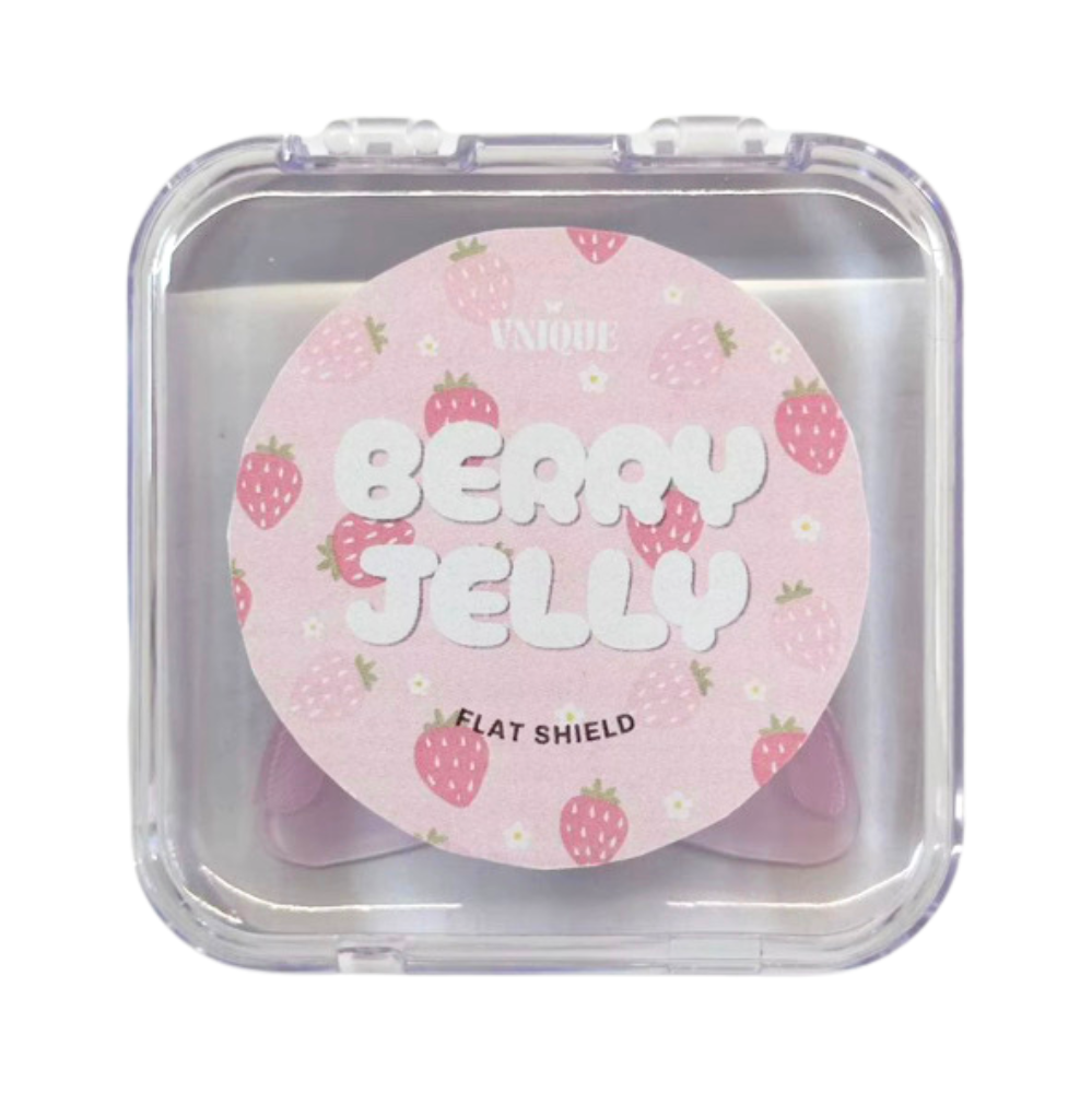 A round pink cosmetic flat shield compact with strawberry illustrations, labeled 'UNIQUE BERRY JELLY FLAT SHIELD,' shown inside a clear plastic square case on a white background.