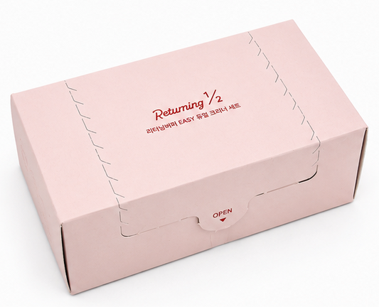 Four views of a light pink product box on a white background, showing the closed exterior, open exterior with white contents, open exterior with a separate insert, and the closed exterior from another angle. The box has red text reading 'Dreaming 1/2' and smaller Korean text.