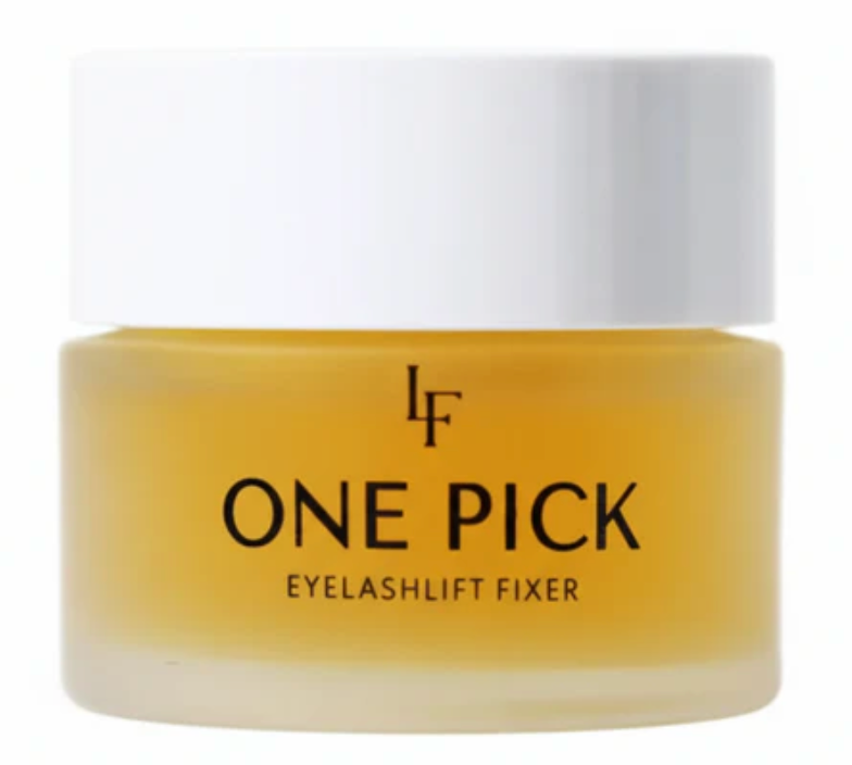 Yellow jar of 'ONE PICK Eyelashlift Fixer' with a white cap on a white background
