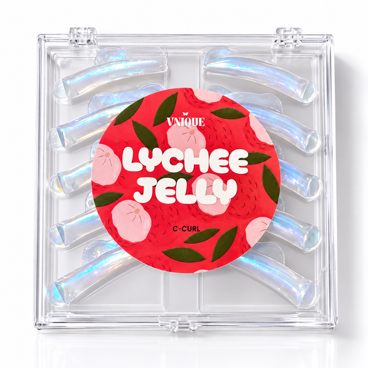 A clear plastic C-Curl compact containing iridescent blue-hued hair extensions, with a red circular sticker reading 'THE UNIQUE LYCHEE JELLY' on the front.